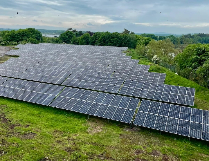 A wide view of a farm with a complete solar installation